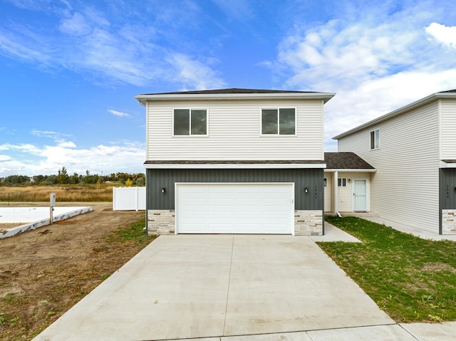 view of front facade featuring a front yard and a garage