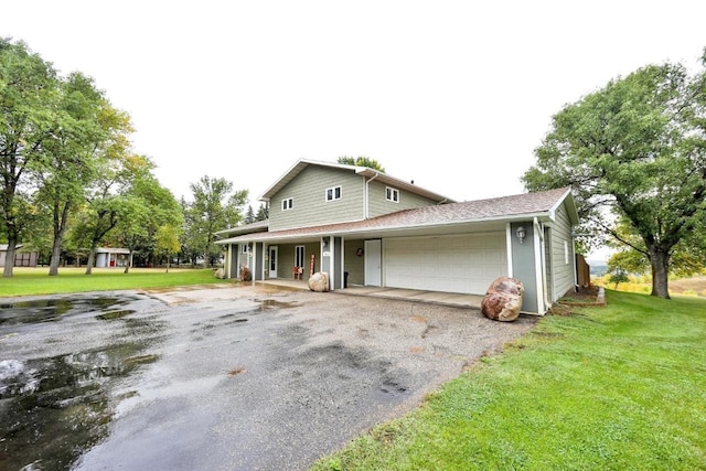 view of front of house featuring a garage and a front yard