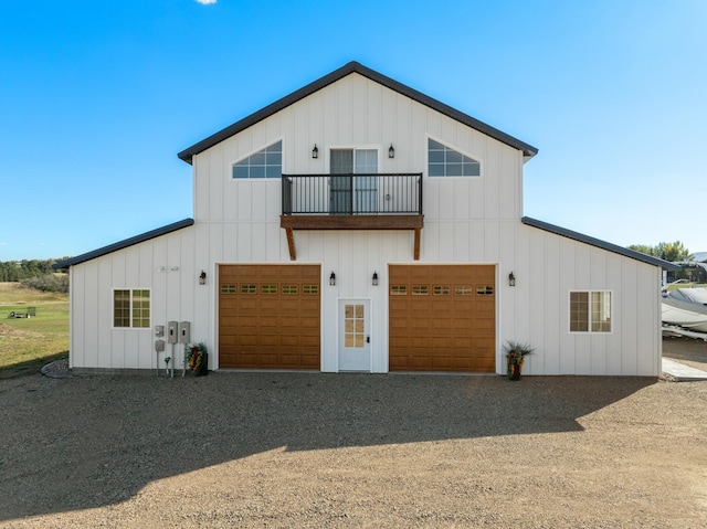 view of front of property featuring a balcony and a garage