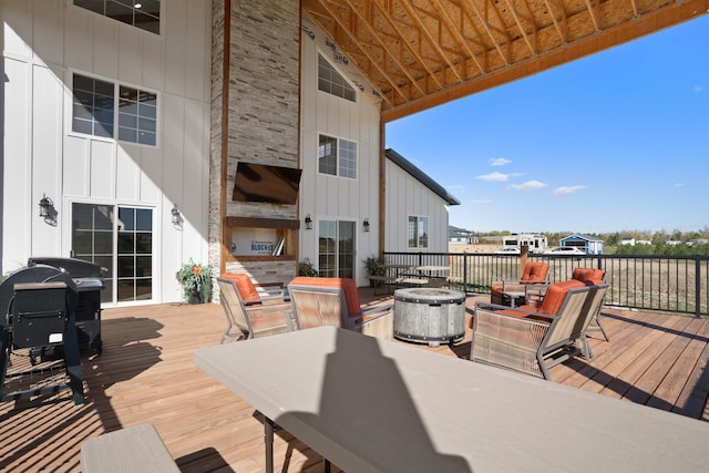 view of patio with area for grilling and a deck