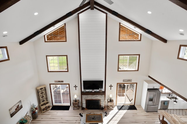 living room featuring plenty of natural light and high vaulted ceiling