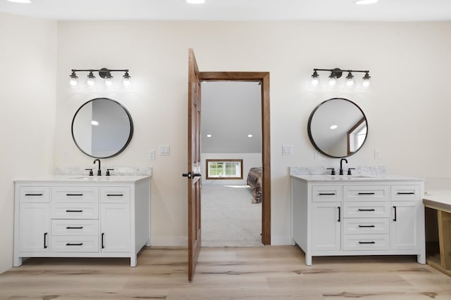 bathroom with wood-type flooring and vanity