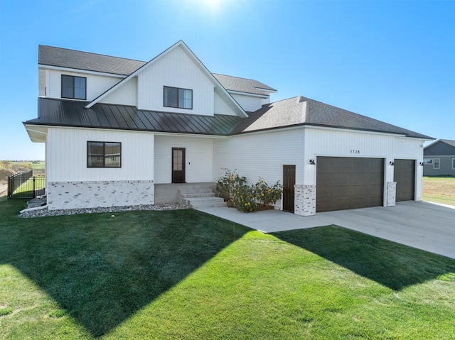 modern farmhouse with a front yard and a garage