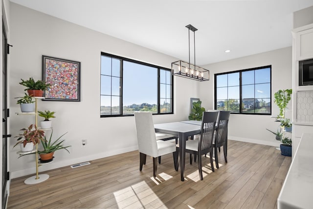 dining area with light hardwood / wood-style floors