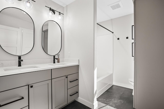 full bathroom featuring vanity, bathtub / shower combination, and toilet