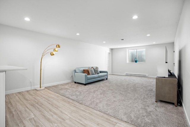 unfurnished living room with baseboard heating and light wood-type flooring