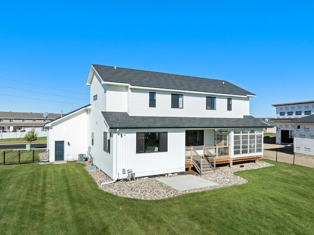 back of house with a lawn, a deck, and central air condition unit