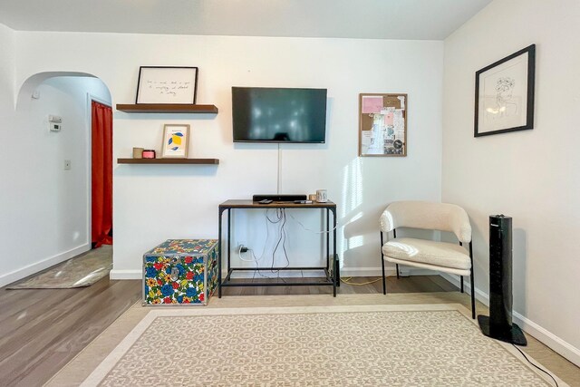 sitting room featuring baseboards and wood finished floors