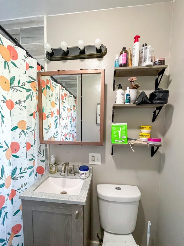 bathroom with vanity, toilet, and a shower with curtain