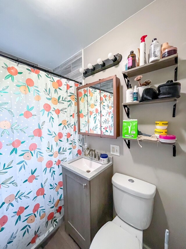 bathroom with toilet, vanity, and a shower with curtain