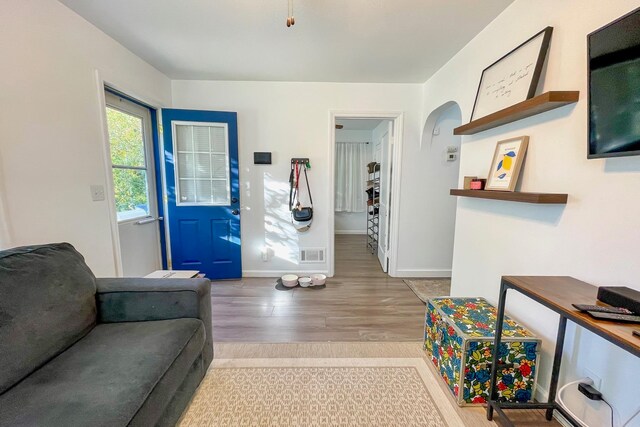 foyer with visible vents, baseboards, and wood finished floors