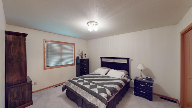 carpeted bedroom with a textured ceiling