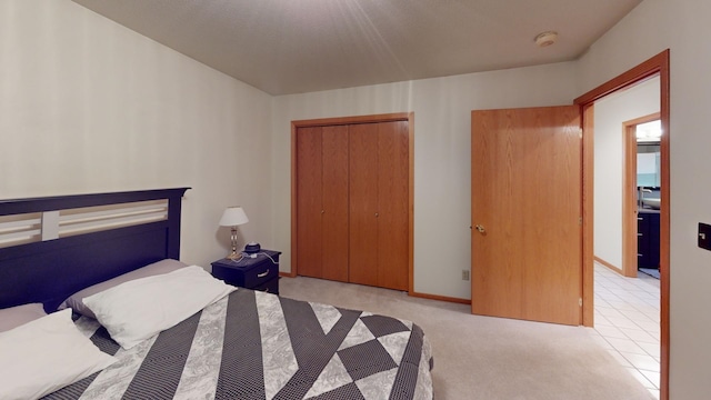 bedroom with light carpet and a closet