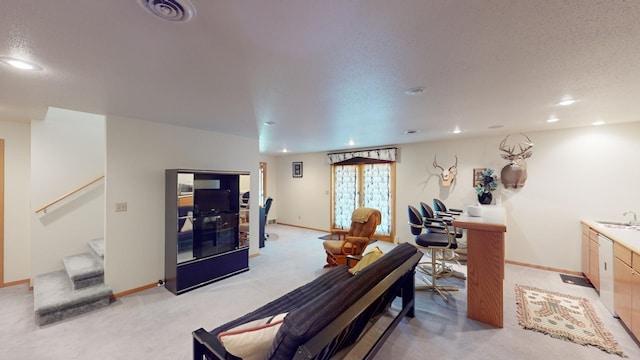 interior space with a textured ceiling and sink