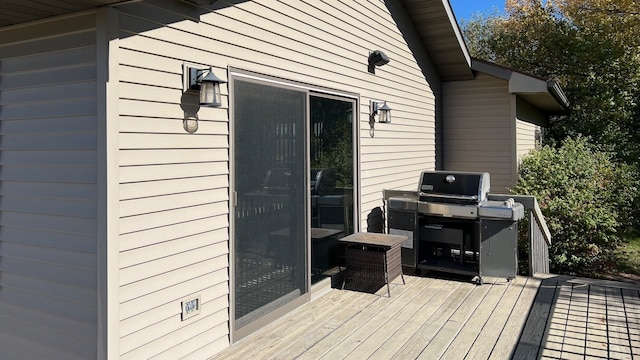 wooden terrace featuring a grill