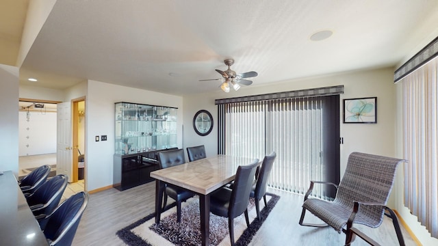 dining room featuring light hardwood / wood-style floors, ceiling fan, and a wealth of natural light