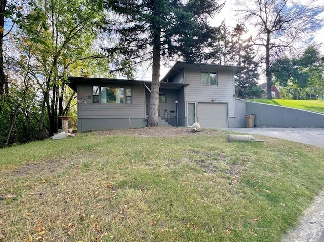 view of front of house with a front lawn and a garage