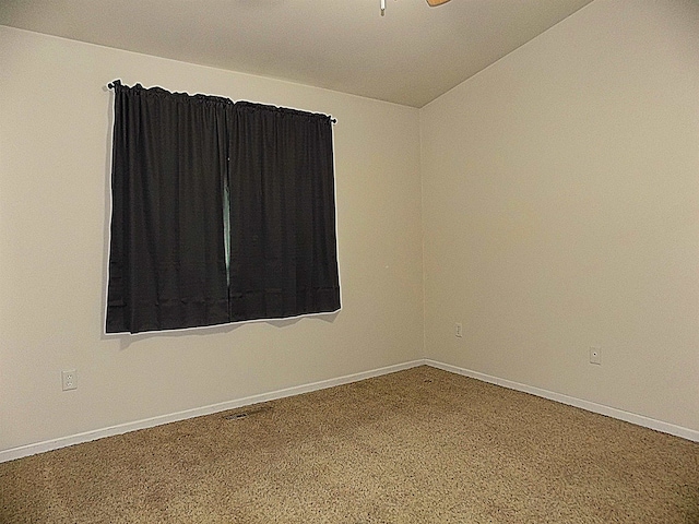 carpeted spare room with lofted ceiling