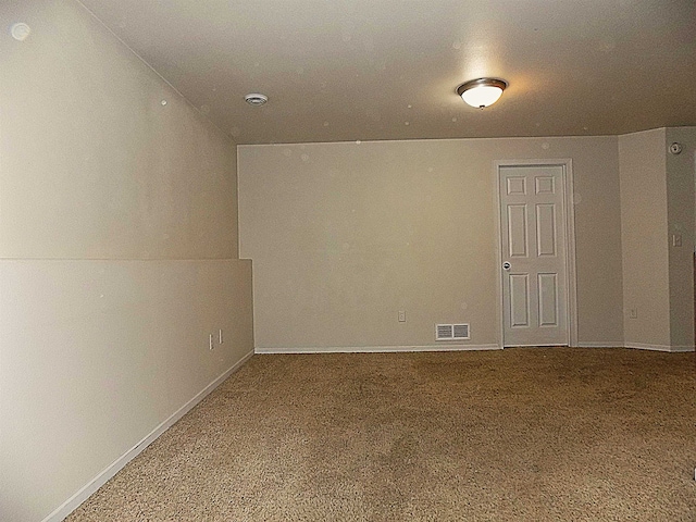 carpeted empty room with lofted ceiling