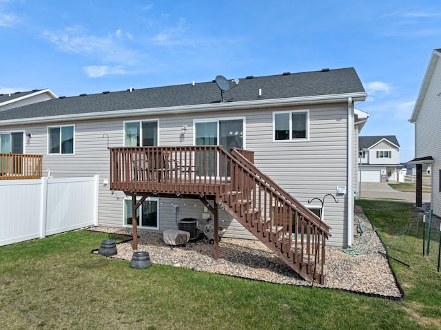 rear view of house with a yard and a deck