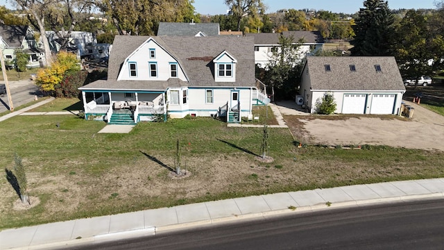 exterior space featuring a porch, a lawn, and a garage