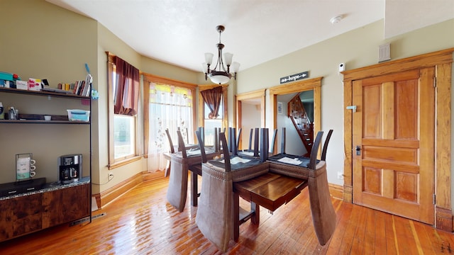 dining room featuring a notable chandelier and hardwood / wood-style floors