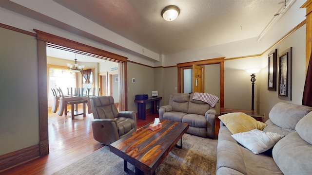 living room featuring hardwood / wood-style floors and a notable chandelier