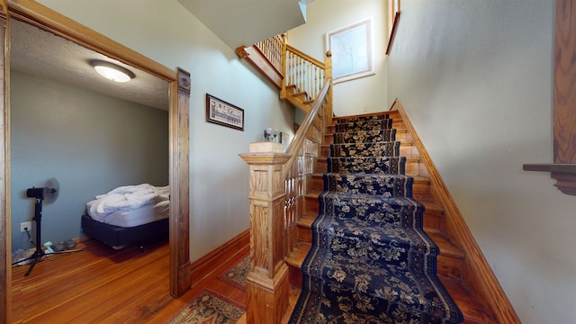 stairway featuring hardwood / wood-style flooring