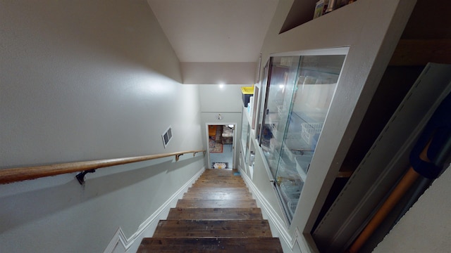 staircase featuring wood-type flooring