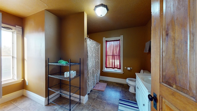 bathroom featuring tile patterned floors, vanity, and toilet