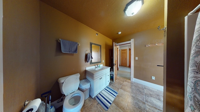 bathroom with vanity, lofted ceiling, toilet, and a textured ceiling