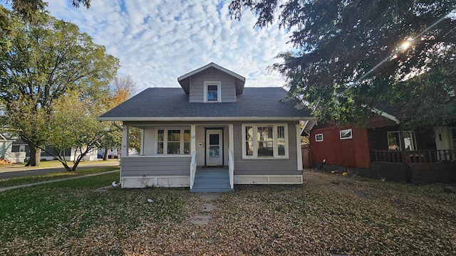 bungalow-style home with a porch and a front yard