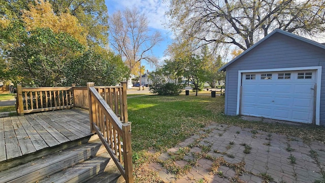 view of yard featuring a deck, an outdoor structure, and a garage