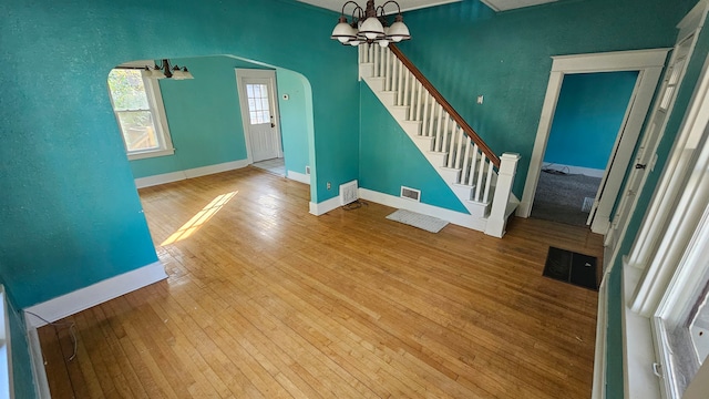 entryway with an inviting chandelier and hardwood / wood-style flooring