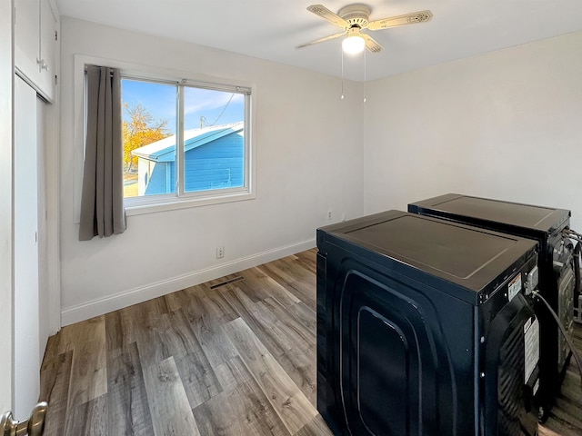 office featuring light hardwood / wood-style floors, washing machine and clothes dryer, and ceiling fan