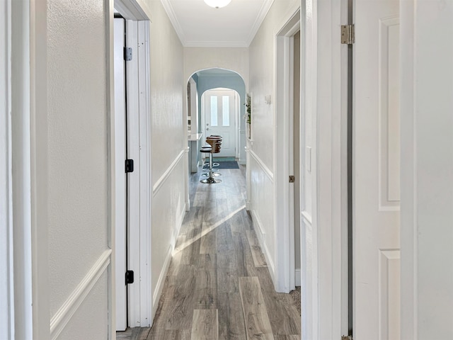 hall featuring crown molding and light hardwood / wood-style flooring