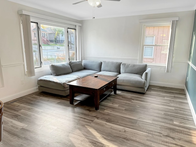 living room with light hardwood / wood-style floors and ceiling fan