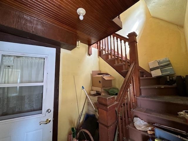 stairway with wooden ceiling