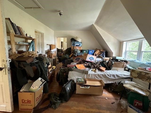 miscellaneous room with lofted ceiling and hardwood / wood-style floors