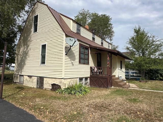 view of side of home featuring a yard