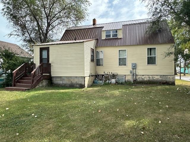 rear view of house with a lawn