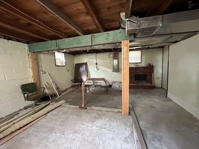 basement featuring electric panel and a fireplace