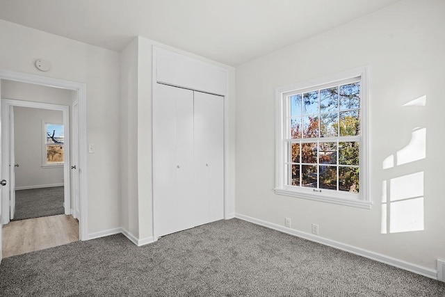 unfurnished bedroom with carpet and a closet