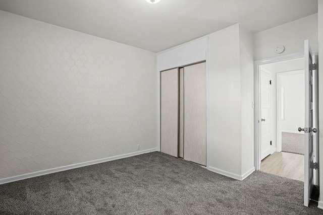 unfurnished bedroom with a closet and carpet