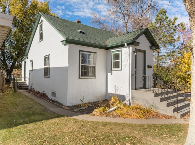 1012 4th St, Minot, ND 58701 - view of front of property featuring a shingled roof, stucco siding, a chimney, and a front yard