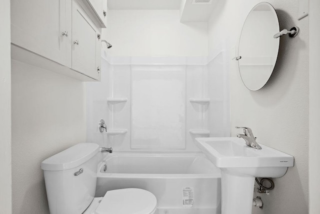 bathroom with shower / tub combination and toilet