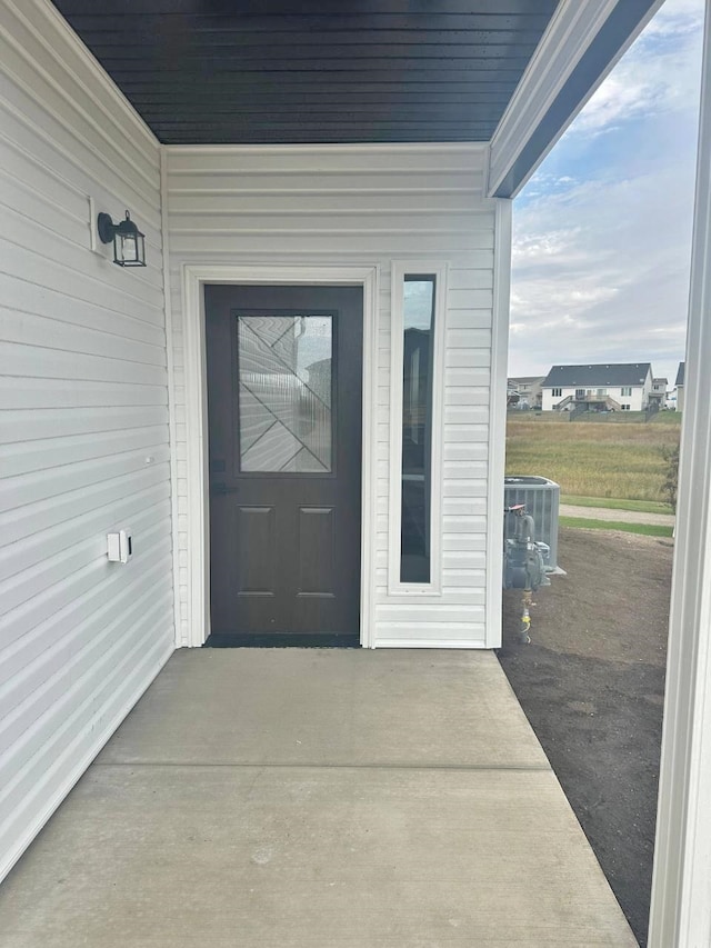 property entrance with central AC and a patio