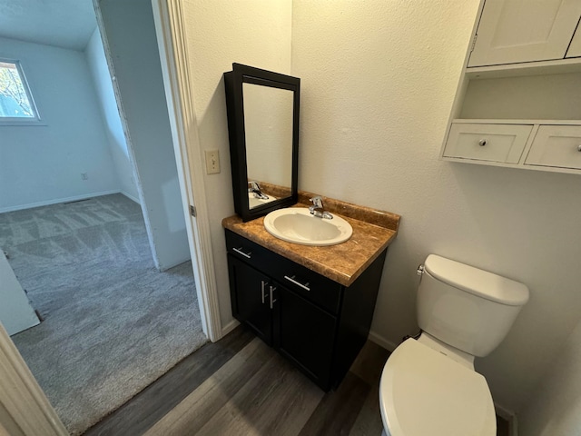 bathroom featuring vanity, toilet, and wood-type flooring