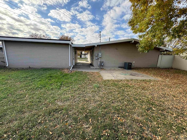 back of house featuring a yard, central air condition unit, and a patio