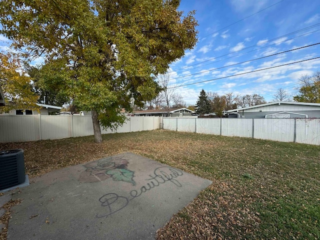 view of yard featuring a patio and central AC